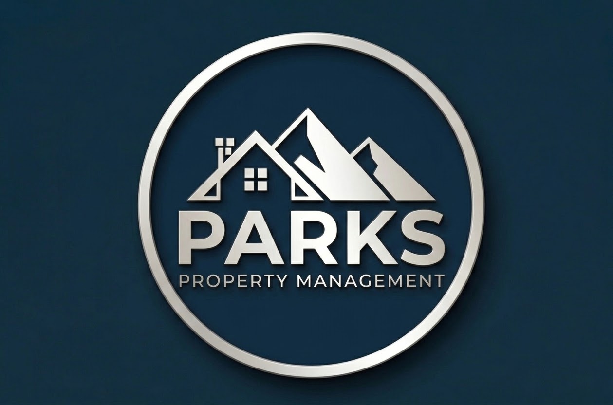 Parks Property Management silver mountain and home emblem on navy